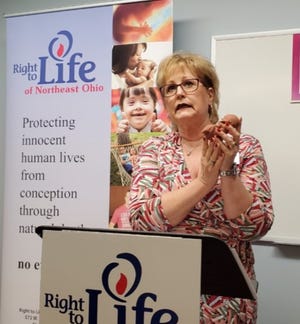 Denise Leipold, executive director of Right to Life of Northeast Ohio, holds a model fetus which she said is about the size of one allegedly found in the trash behind a Cuyahoga Falls abortion clinic.
