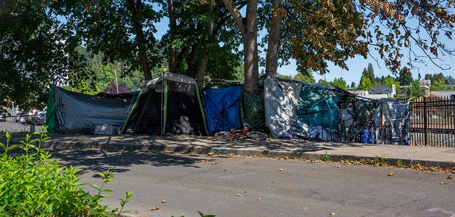 The city of Eugene gave the occupants of this grouping of tents on Sixth Avenue and High Street a 72-hour notice to move from the location in July.