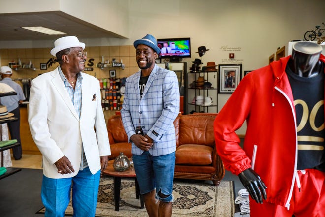 Hot Sam's Detroit co-owner Tony Stovall, 69, of Southfield, left, helps create a look for Matthew Landenberger, who will be modeling during their 100-year anniversary celebration at Campus Martius Park and Cadillac Square this weekend.
