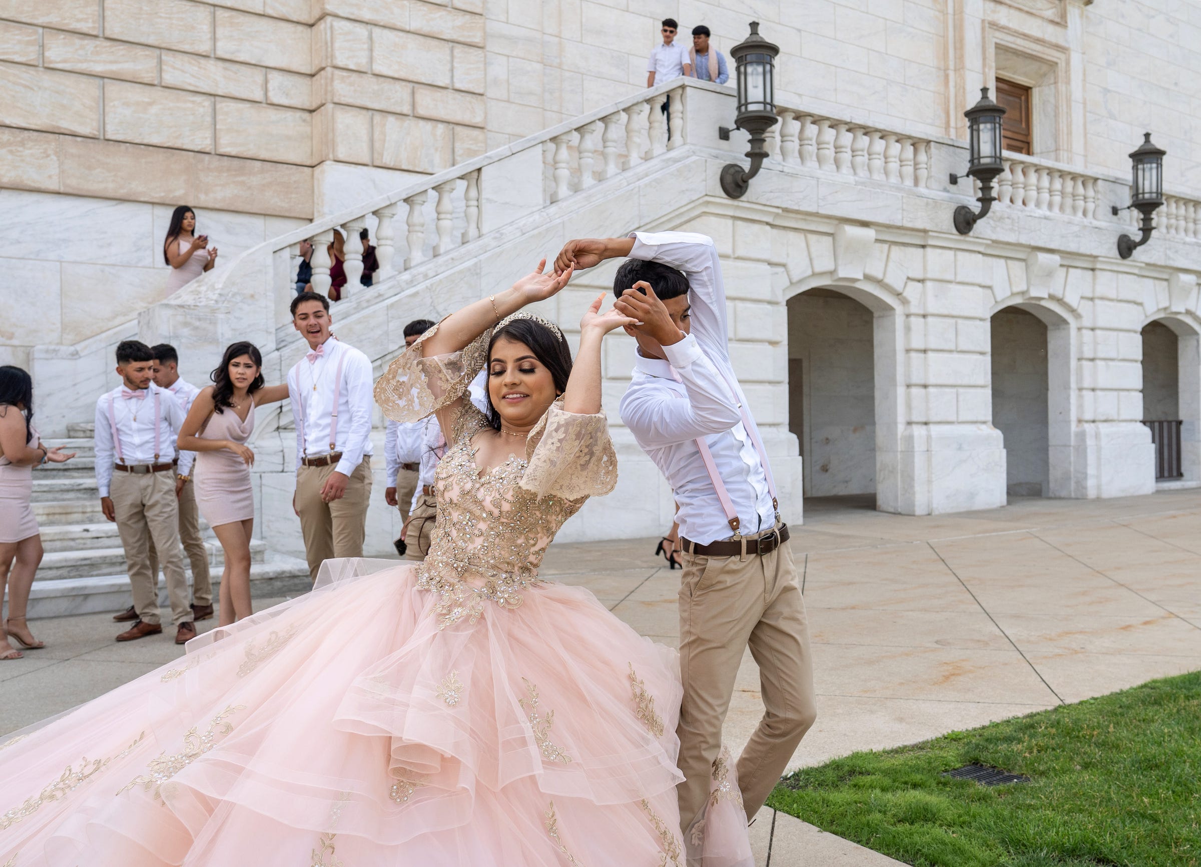 Estefania Velazquez of Detroit practices her dance with the court of honor while stopping for a photo shoot at the staircase at the rear of the Detroit Institute of Arts on Friday, June 18, 2021.
