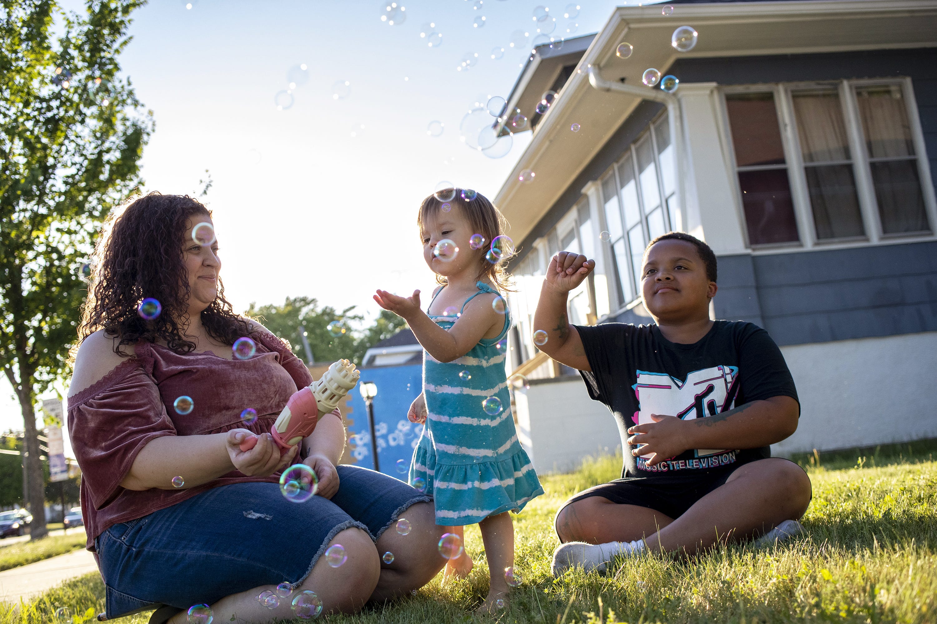 Jaleesa Gray plays with her children outside her home June 15, 2021, Green Bay, Wis.