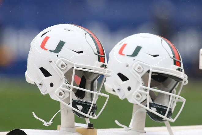 Miami Hurricanes helmets sit on the sidelines during a game against the Pittsburgh Panthers.