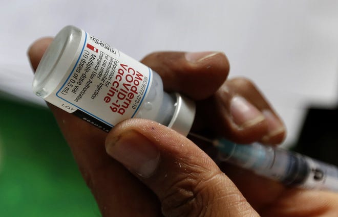 A health worker prepares a Moderna COVID-19 vaccine at a vaccination center, in Lahore, Pakistan, Tuesday, July 6, 2021. Normalcy returned at COVID-19 vaccination centers across Pakistan days after Washington delivered 2.5 million doses of the Moderna vaccine to Islamabad. That enabled Pakistan's government to overcome shortages of specific vaccines which were needed to inoculate expatriate workers wishing to travel abroad. (AP Photo/K.M. Chaudary)