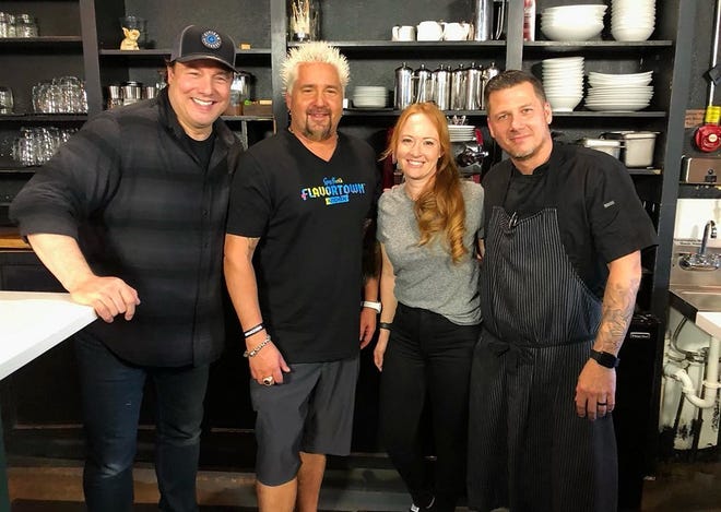 Food Network star Guy Fieri (second from left) poses for a photo with chef Tim Lipman and Jenny Lipman (right), owners of Coolinary Café in Palm Beach Gardens in February 2021. They are joined by star chef Rocco DiSpirito, left.