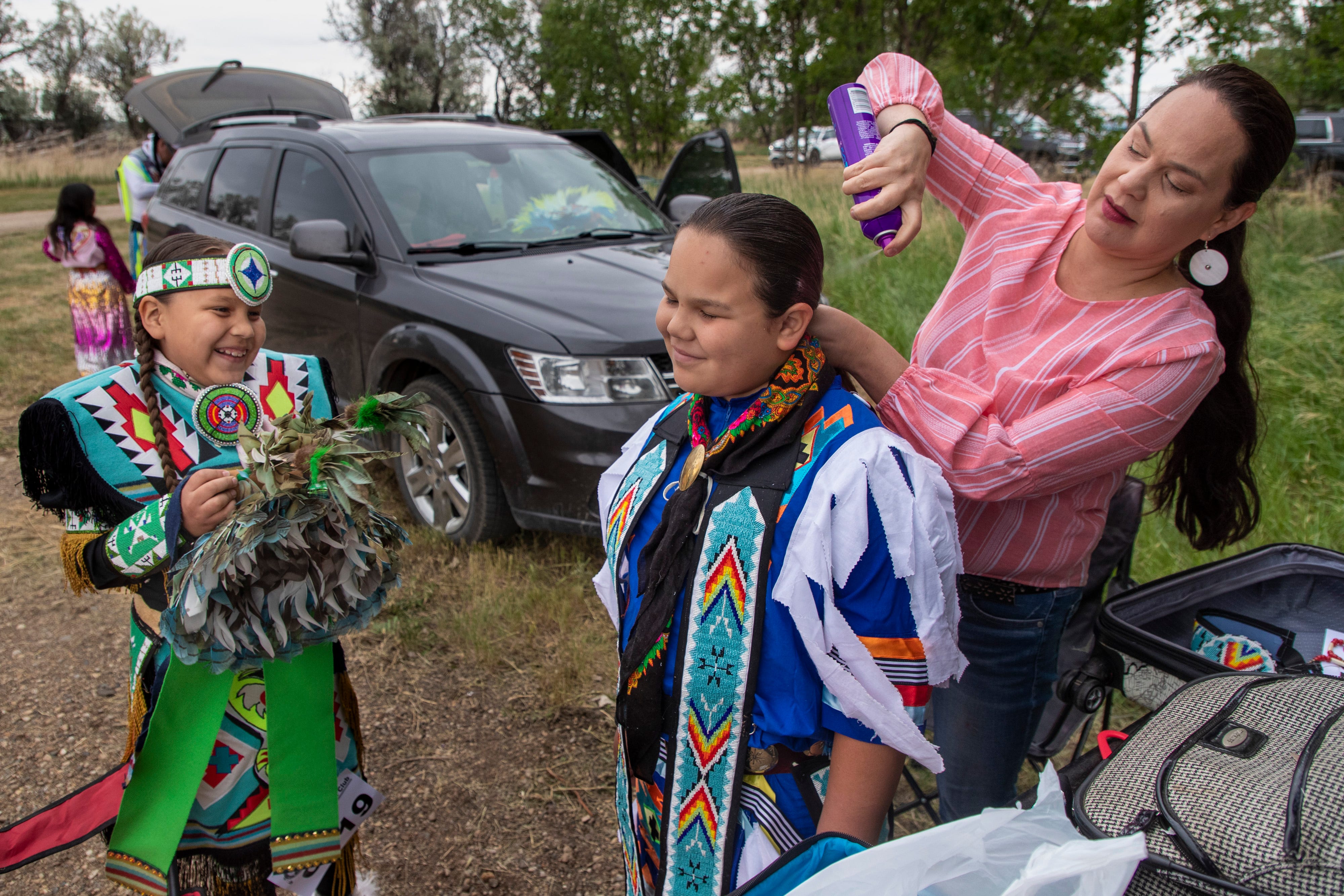 Children are readied for dancing at the Santee Lucky Mound Pow Wow in Parshall, North Dakota. June 25, 2021