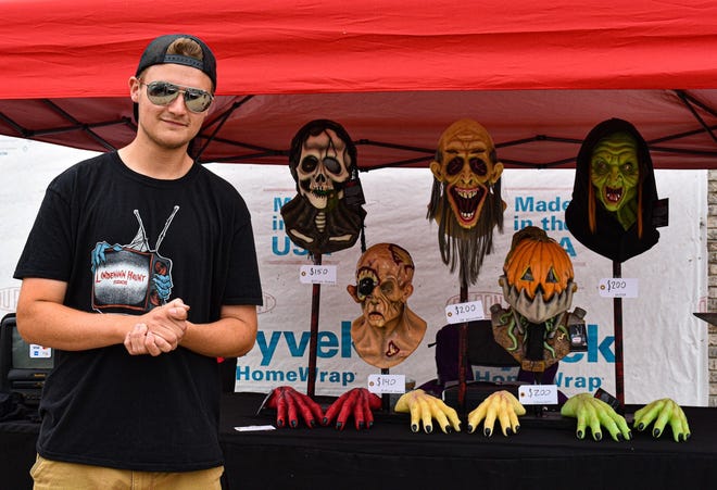 Austin Lindmann stands with a few of his handmade latex masks and gloves at the June 24 Art Walk hosted by the Greater Port Clinton Area Arts Council in downtown Port Clinton. Lindemann will also be at the July 22 Art Walk.
