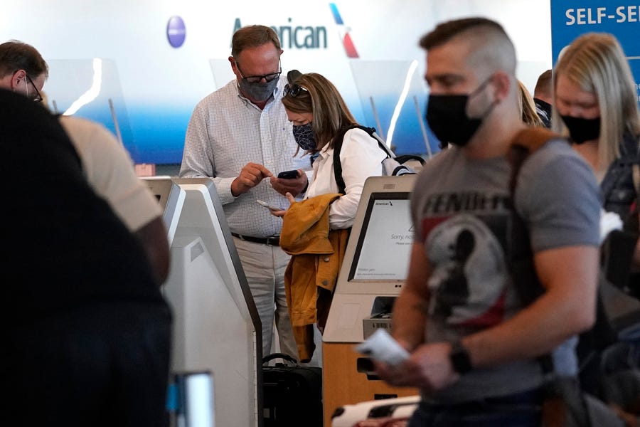 Travelers check in at the American Airlines self-ticket counter at Chicago's O'Hare International Airport on July 2.