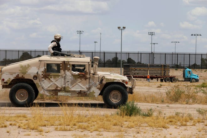Members of the Mexican National Guard patrol along the Rio Grande, near the construction site of a new section of the border wall between El Paso, Texas, and Ciudad Juarez, Mexico, on August 17, 2020. (Herika Martinez/AFP via Getty Images/TNS)