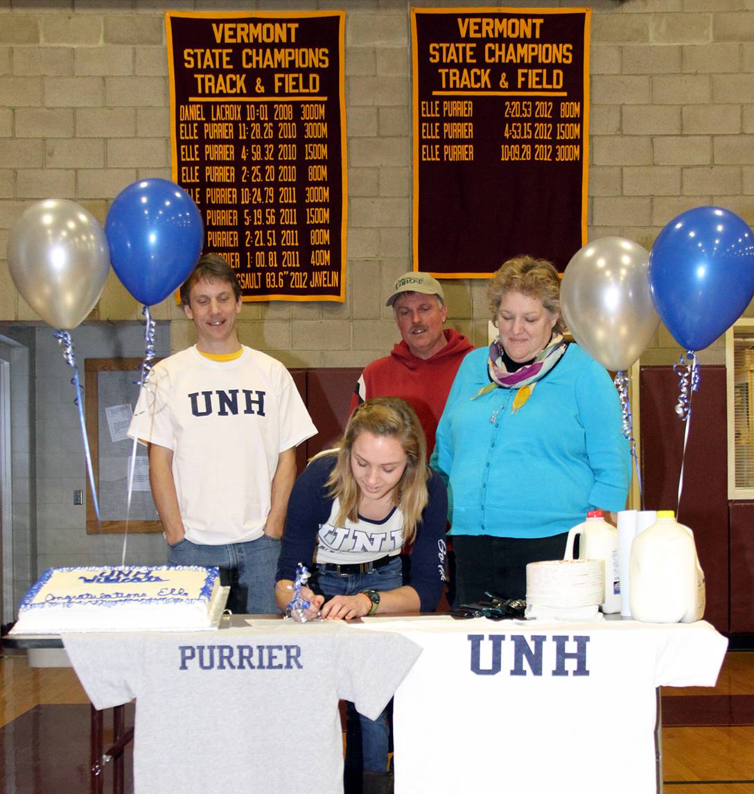 Elle Purrier St. Pierre signs her National Letter of Intent with New Hampshire in this February 2013 file photo. Purrier's coach, Andrew Hathaway (left) and her parents, Charles and Annie Purrier, look on during the signing in the Richford High School gym.