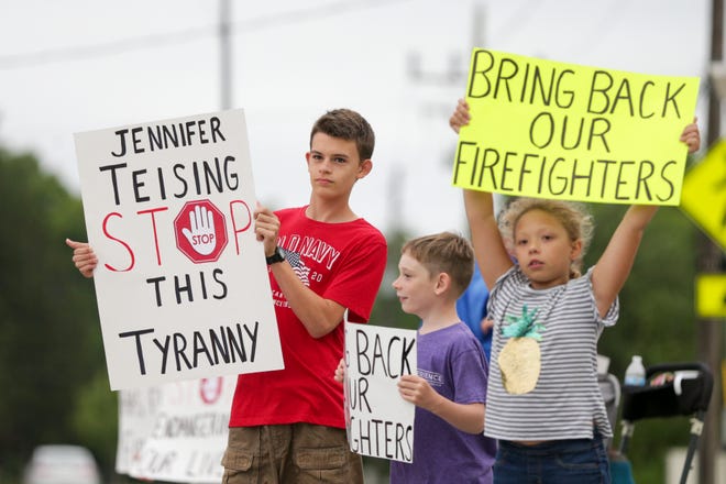 A group of Wabash Township residents protest embattled Wabash Trustee Jennifer Teising along Happy Hollow Road, Thursday, July 8, 2021 in West Lafayette.