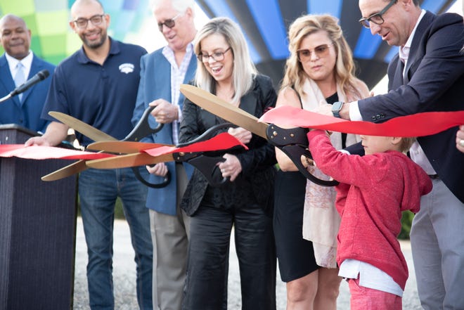 Cutting the ribbon to welcome the opening of the new Glow Plaza, part of the Neon Line District, established by Jacob's Entertainment and the Sands Regency Casino and Hotel on July 9, 2021.