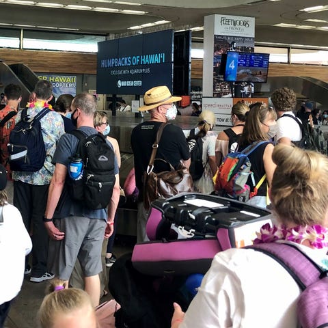 Travelers arriving at Maui's Kahului Airport wait 