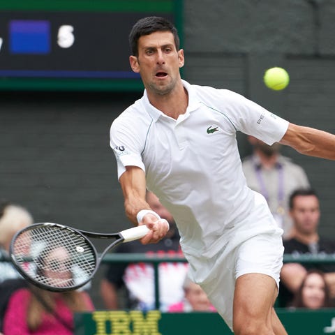 Novak Djokovic hits a running forehand Friday duri