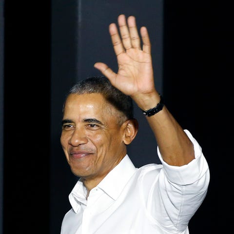 Former President Barack Obama waves as he enters a