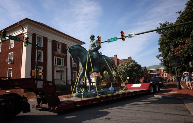 A flatbed truck carries a statue of Confederate General Robert E. Lee from the Market Street Park on July 10, 2021, in Charlottesville, Virginia.
