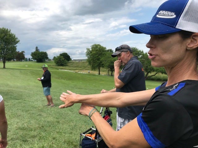 Five-time disc golf world champion Juliana Korver explains the mechanics of throwing a disc on a windy day while competing in the Disc Golf Pro Tour event at Pickard Park in Indianola July 10, 2021. Korver, a graduate of University of Northern Iowa is also the designer of the course, which opened in 1999.