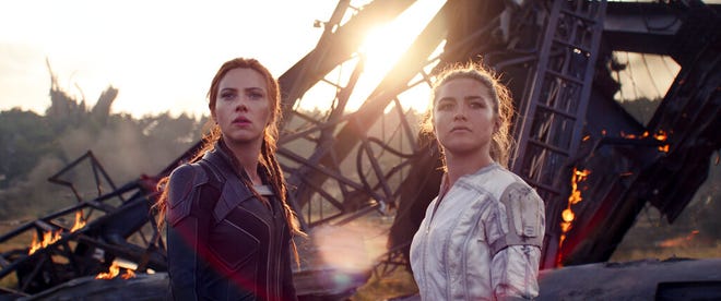 This image released by Marvel Studios shows Scarlett Johansson, left, and Florence Pugh in a scene from "Black Widow." (Marvel Studios-Disney via AP)
