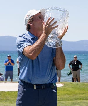 Vinny Del Negro kisses' the championship trophy the ACC Golf Tournament at Edgewood Tahoe Golf Course in South Lake Tahoe on Sunday, July 11, 2021.