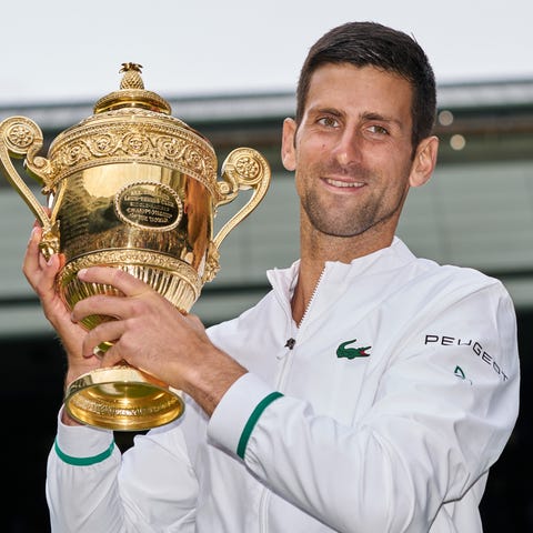 Novak Djokovic celebrates with the championship tr
