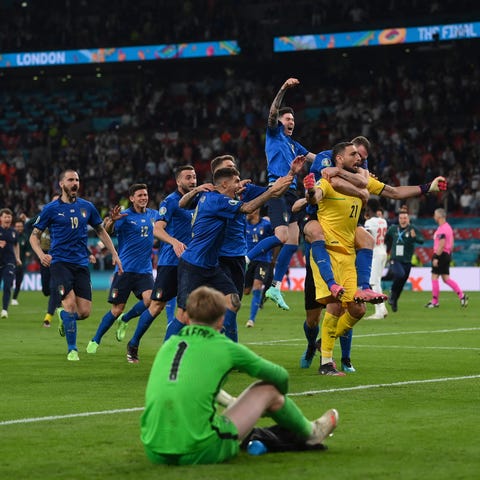 Italian players celebrate after the penalty shooto