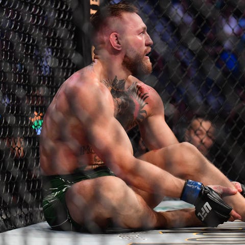 Conor McGregor reacts after suffering an injury in
