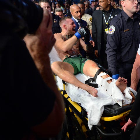Conor McGregor is carried off on a stretcher follo
