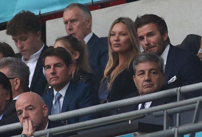 Tom Cruise (CL) and England footballer David Beckham (CR) during the UEFA EURO 2020 final soccer match between Italy and England at Wembley Stadium in London.