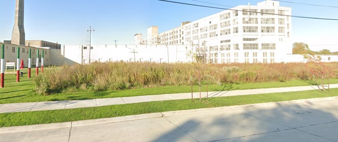 A Bay View vacant lot, now zoned for industrial use, could be the site of a new four-story apartment building.