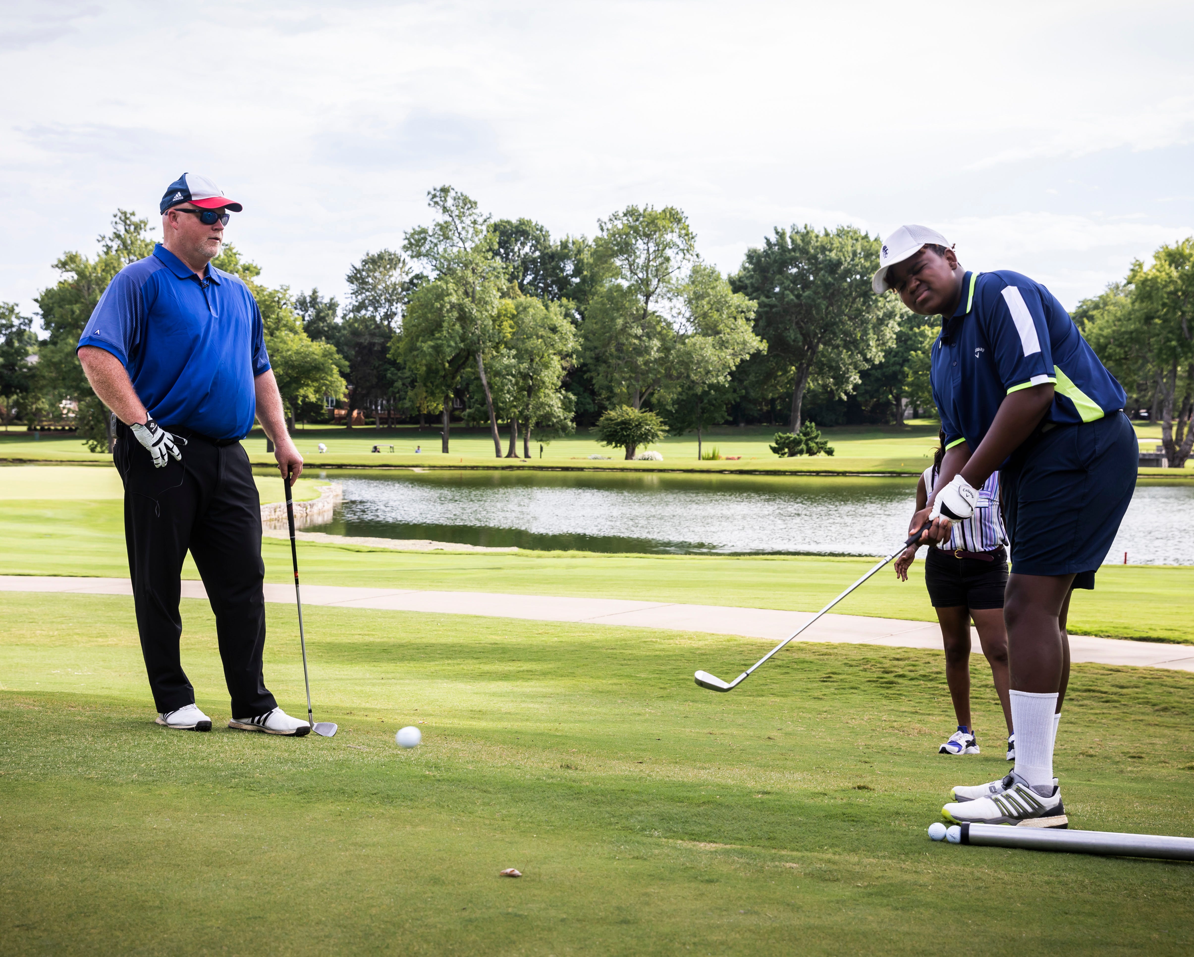 Three-time national champion blind golfer Chad NeSmith, left, teaches Malachi Johnson, who has lost the ability to see, to play the sport Saturday, July 10, 2021 at the Brentwood Country Club.