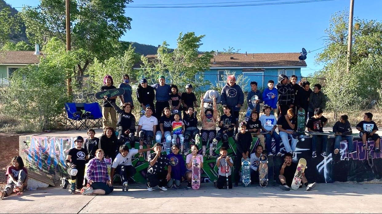 Skateboarders and roller skaters from the Fort Apache Indian Reservation pose for a photo with their skate clinic instructors in Whiteriver on May 22, 2021.