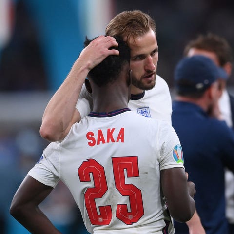 England's Harry Kane consoles teammate Bukayo Saka