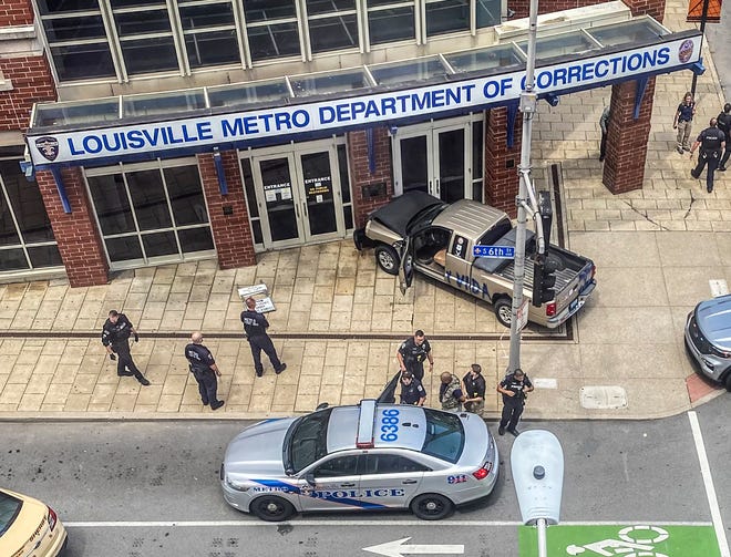 Officers arrest the driver of a pickup that crashed into the Louisville Metro Department of Corrections on Tuesday, July 13, 2021.