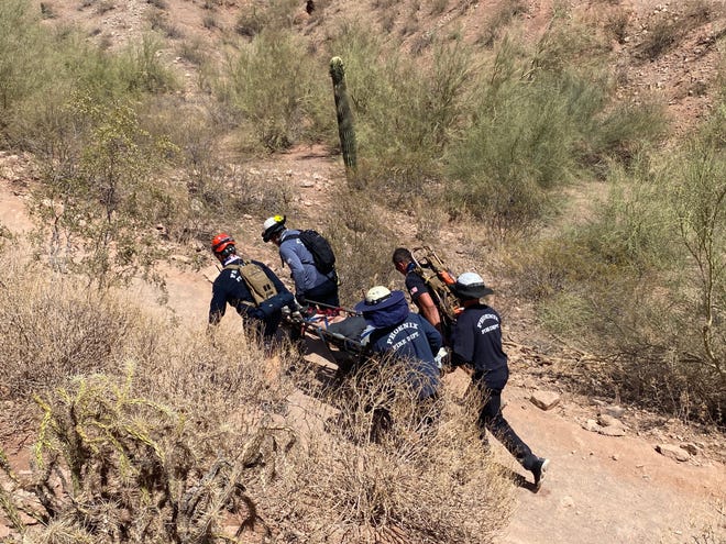 The Phoenix Fire Department's Technical Rescue Team transport a man off Camelback Mountain on May 31, 2021.