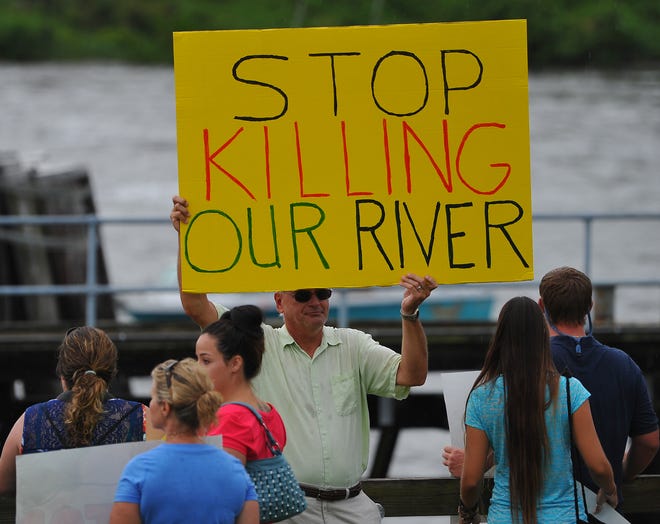 Palm City's John Kane protests in front of the St. Lucie Locks where water from Lake Okeechobee is released into the St. Lucie River during an Indian River Lagoon rally at Phipps Park in Tropical Farms in 2013. An estimated 5,000 people participated in the event.