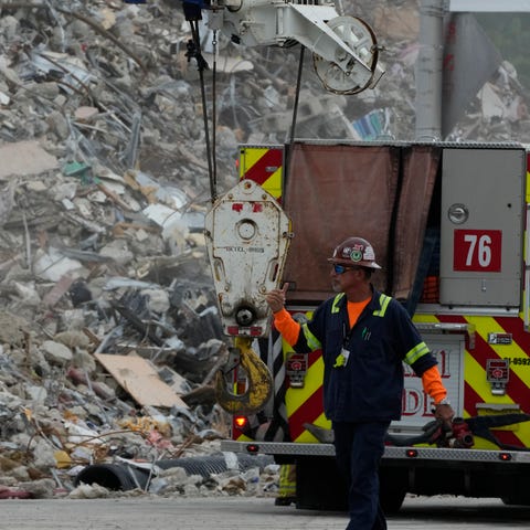 Crews work in the rubble of the demolished section