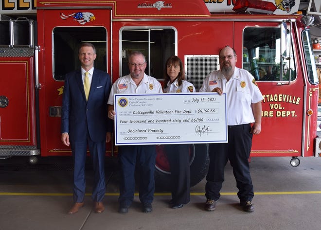 State Treasurer Riley Moore presents an unclaimed property check to Cottageville VFD Chief Michael Morrison, Assistant Chief Cindy Morrison and Deputy Chief Gregory Jewell.