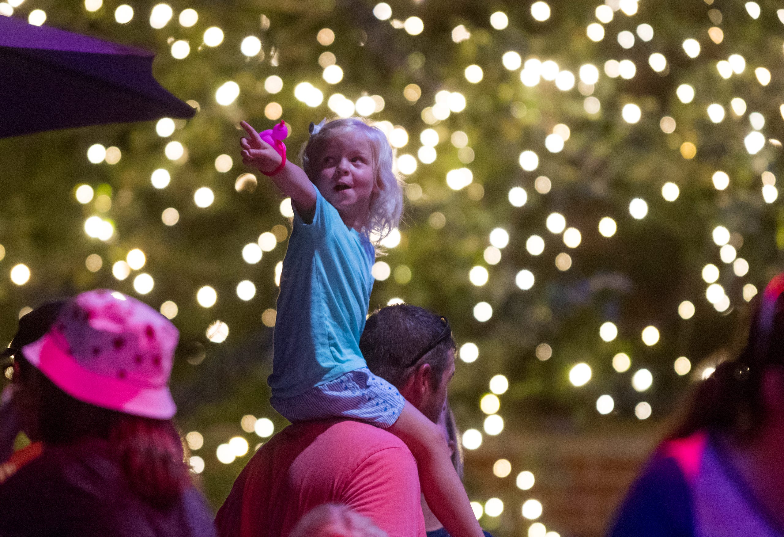 Three-year-old Harper Evitts points to the moon while waiting in line for ice cream on the shoulders of her uncle Eric Blackwell at Bosse Field in Evansville, Ind., Wednesday evening, July 14, 2021.