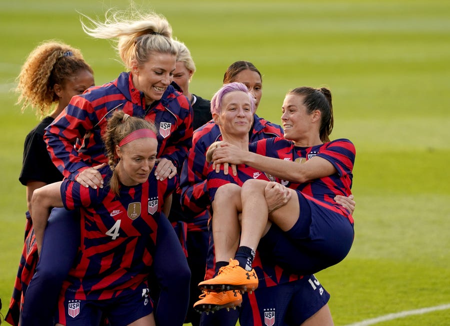 Jul 5, 2021; East Hartford, Connecticut, USA; USA forward Megan Rapinoe (15) holds up defender Kelley O'Hara (5) with other teammates after defeating Mexico during a USWNT Send-off Series soccer match at Pratt & Whitney Stadium. USA defeated Mexico 4-0. Mandatory Credit: David Butler II-USA TODAY Sports