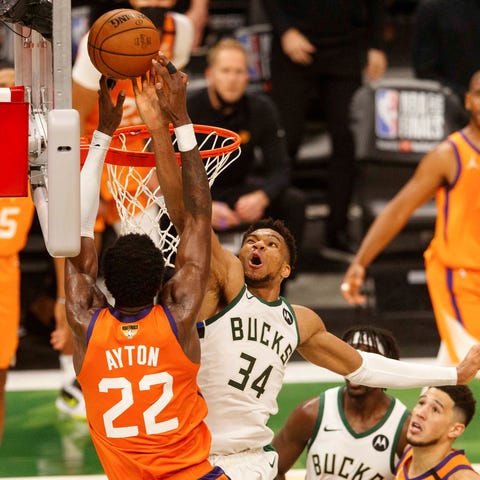 Giannis Antetokounmpo blocks a shot by the Suns' D