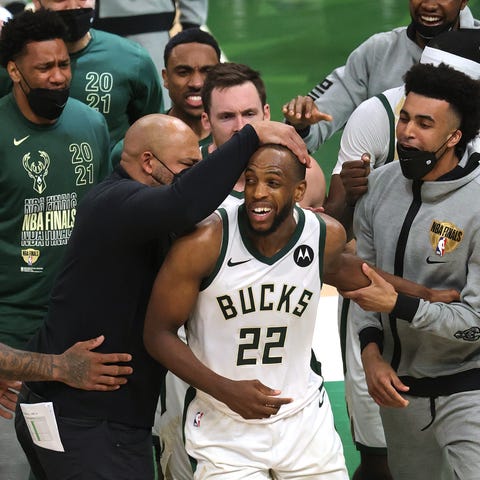 Khris Middleton #22 of the Milwaukee Bucks is cong
