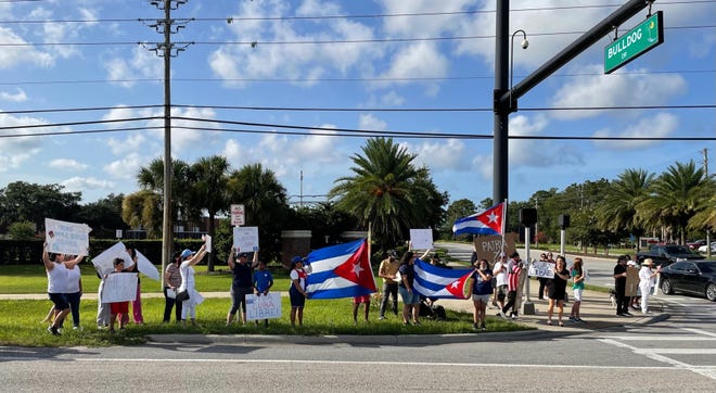 The demonstrators spread out along State Road 100 to increase visibility and drew almost constant support from passing cars.