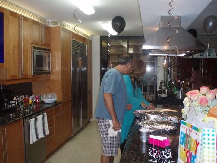 Manny and Adriana LaFont seen in the Unit 801 kitchen for a birthday party