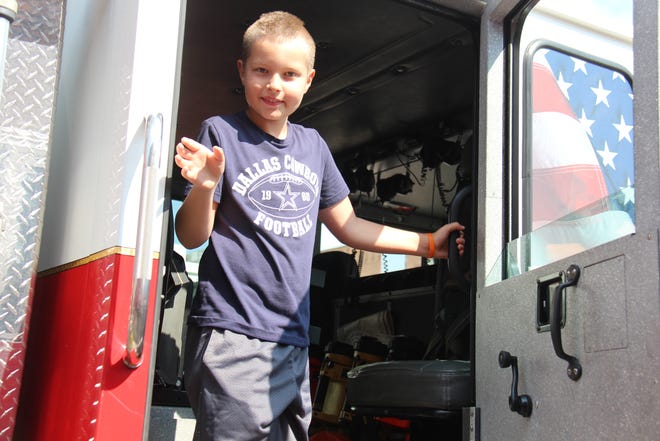 Jackson Sass explores one of the Perry Volunteer Fire Department trucks on display during Public Safety Night at the Perry Farmers Market on Thursday, July 15, 2022.