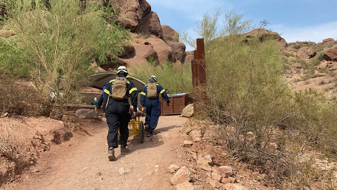 Members of the Phoenix Fire Department's Technical Rescue Team begin a mountain rescue on Echo Canyon Trail at Camelback Mountain on July 11, 2021.