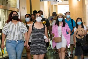 Visitors wear masks as they walk in a shopping district, in the Hollywood section of Los Angeles on July 1. Coronavirus cases have jumped 500% in Los Angeles County over the past month and health officials warned Tuesday that the especially contagious delta variant of the disease continues to spread rapidly among the unvaccinated.