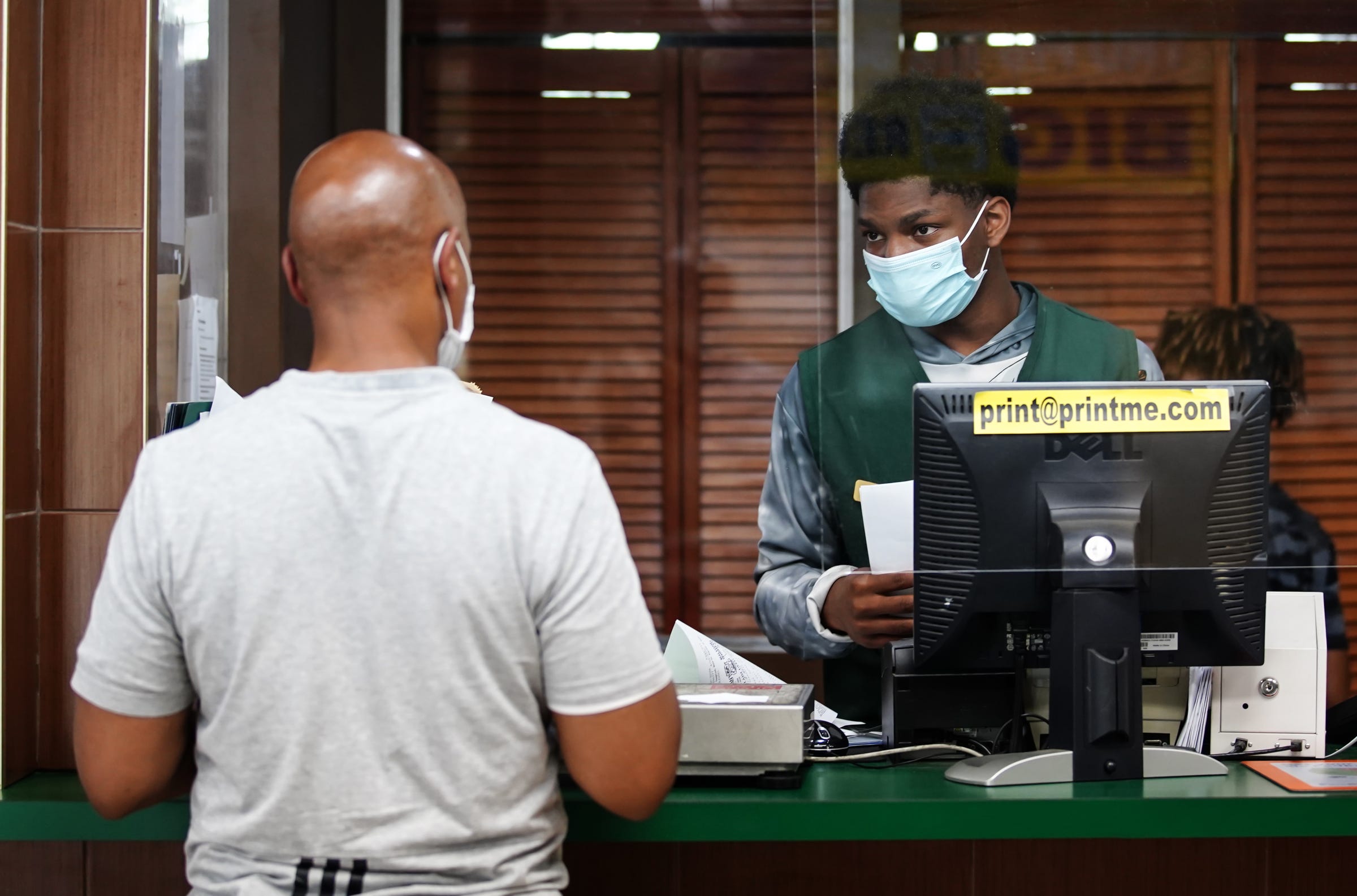 Jazel Hall, 19, of Detroit helps customers at Hallstarz Business Center in Detroit on July 15, 2021. The business center is a one-stop-shop in the Bagley neighborhood. A neighborhood source for packing, shipping, printing and other business services. Created 36 years ago by a Detroit couple, Milton Hall Jr. and Vanessa Hall. The business is now run by their oldest son, Mario Hall with help from his five brothers.