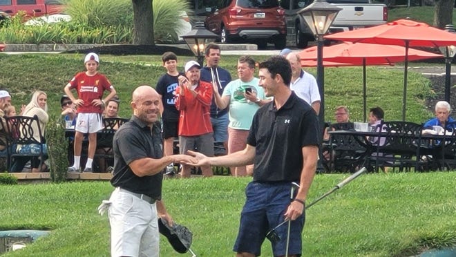 Steve Goodley, left, shakes hands with Zach Dixon after Goodley won the York County Amateur on Sunday in a playoff at Heritage Hills Golf Resort.