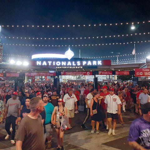 People are seen leaving the Nationals Park stadium