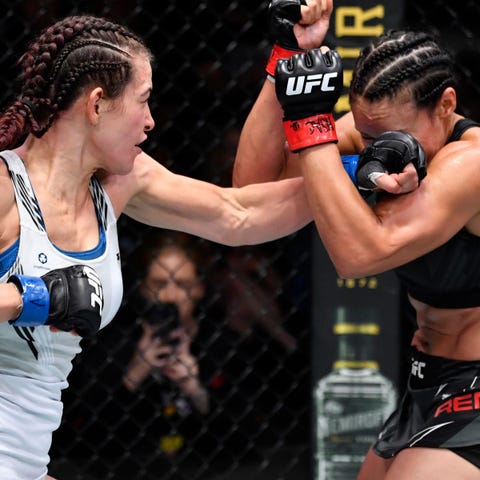 Miesha Tate, left, lands a punch against Marion Re