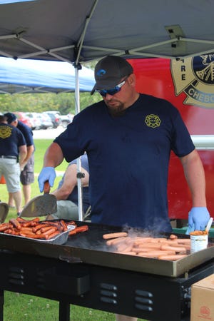 More than 800 hotdogs were served to members of the community who participated in the annual Cheboygan Fire Department Kids' Day Picnic Sunday afternoon. Members of the fire department, including Gabe Jones, took turns grilling the hotdogs and handing out chips and orange drink.